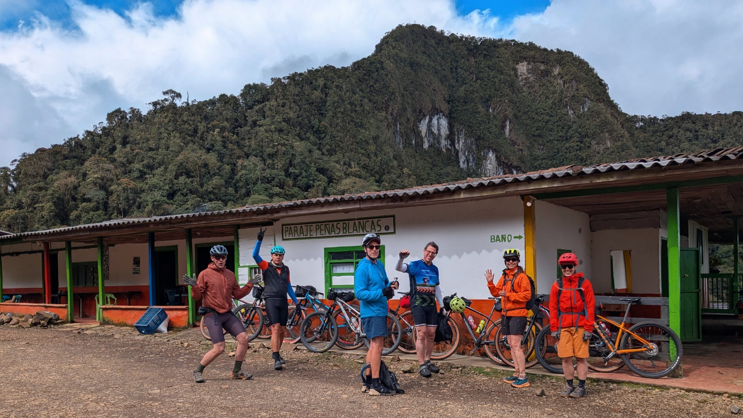 Cyclists celebrating at Peñas Blancas during a Colombia cycling tour